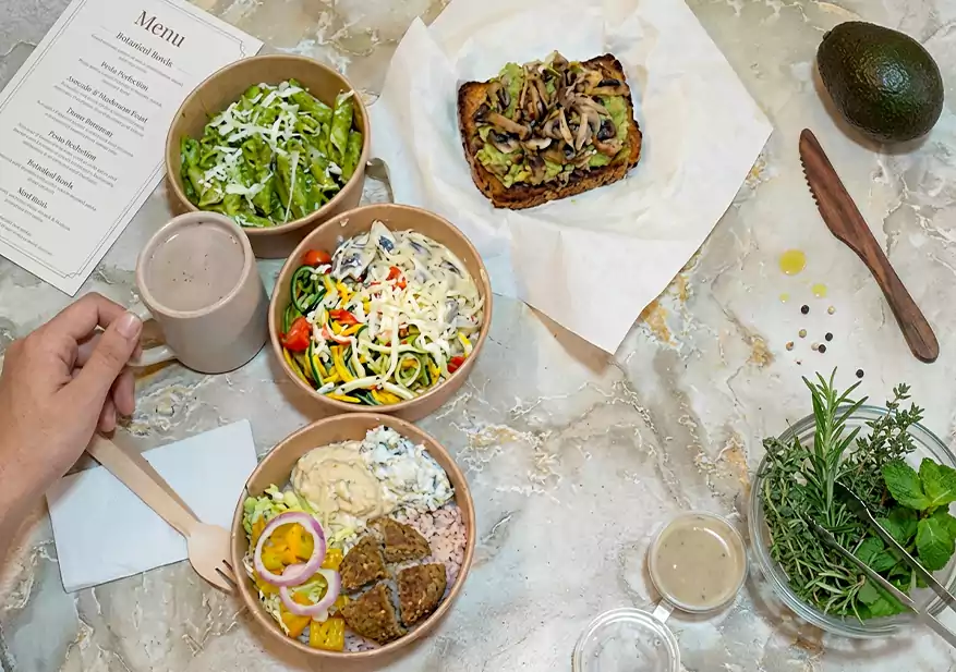 Assorted meal bowls with salad, toast, and wholesome sides served on a table