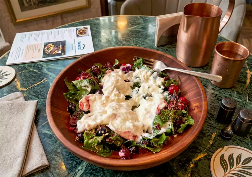 Fresh green salad topped with creamy white dressing