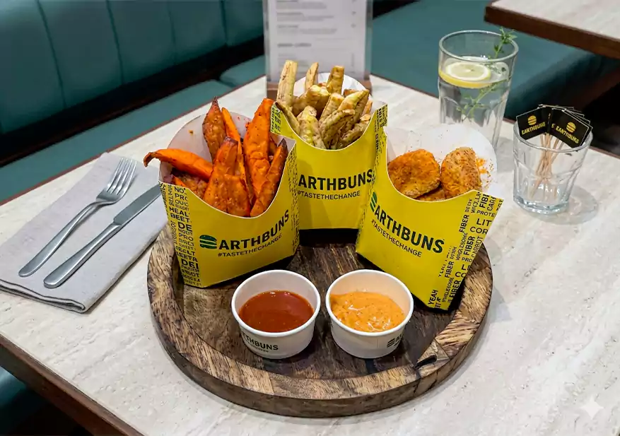 Golden potato wedges served with crispy nuggets and dipping sauces on a tray