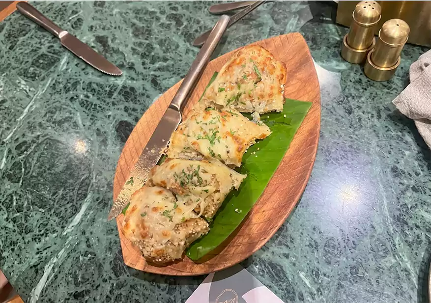 Toasted multigrain garlic bread slices on a leaf