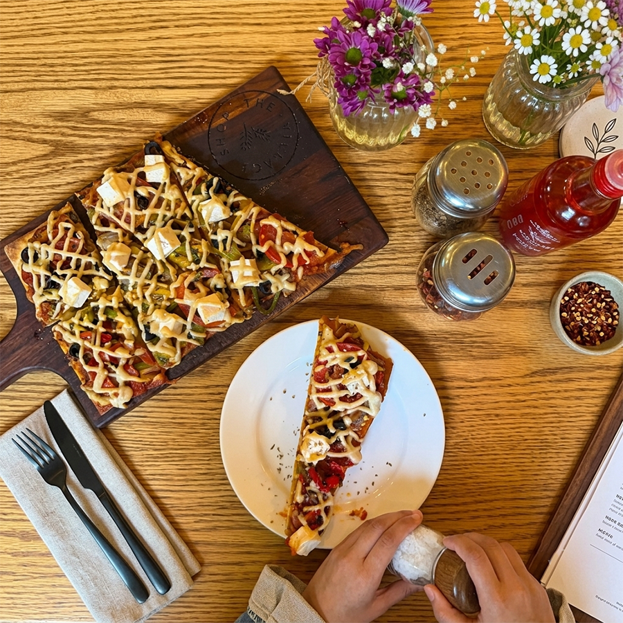 Mediterranean flatbread topped with feta cheese and fresh vegetables