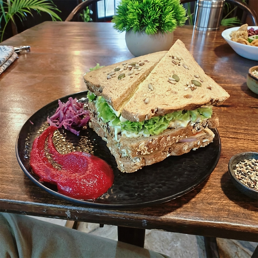Toasted multigrain sandwich served with beetroot chutney and fresh salad greens.