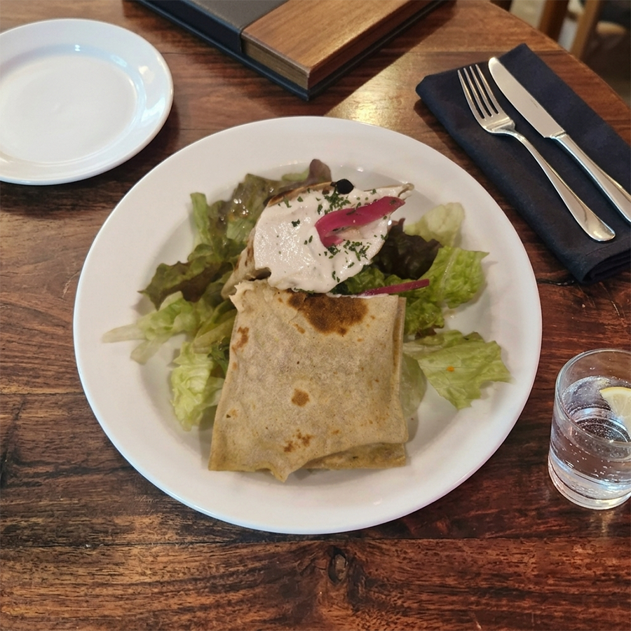 Vegetable wrap served with side salad and yogurt dip.