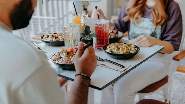 People sharing a meal while dining out at a restaurant